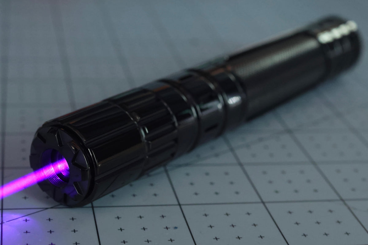 Violet laser prototype on an engineering cutting mat